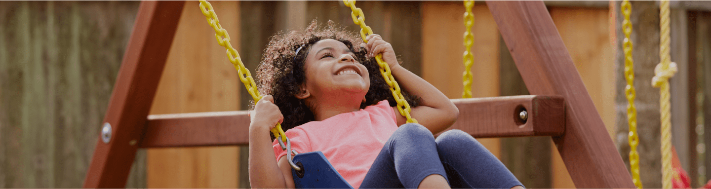 Contact Us Hero - Child on a Swing