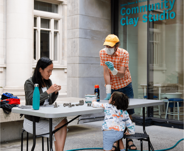 Diverse family working together with clay at the Community Clay Studio