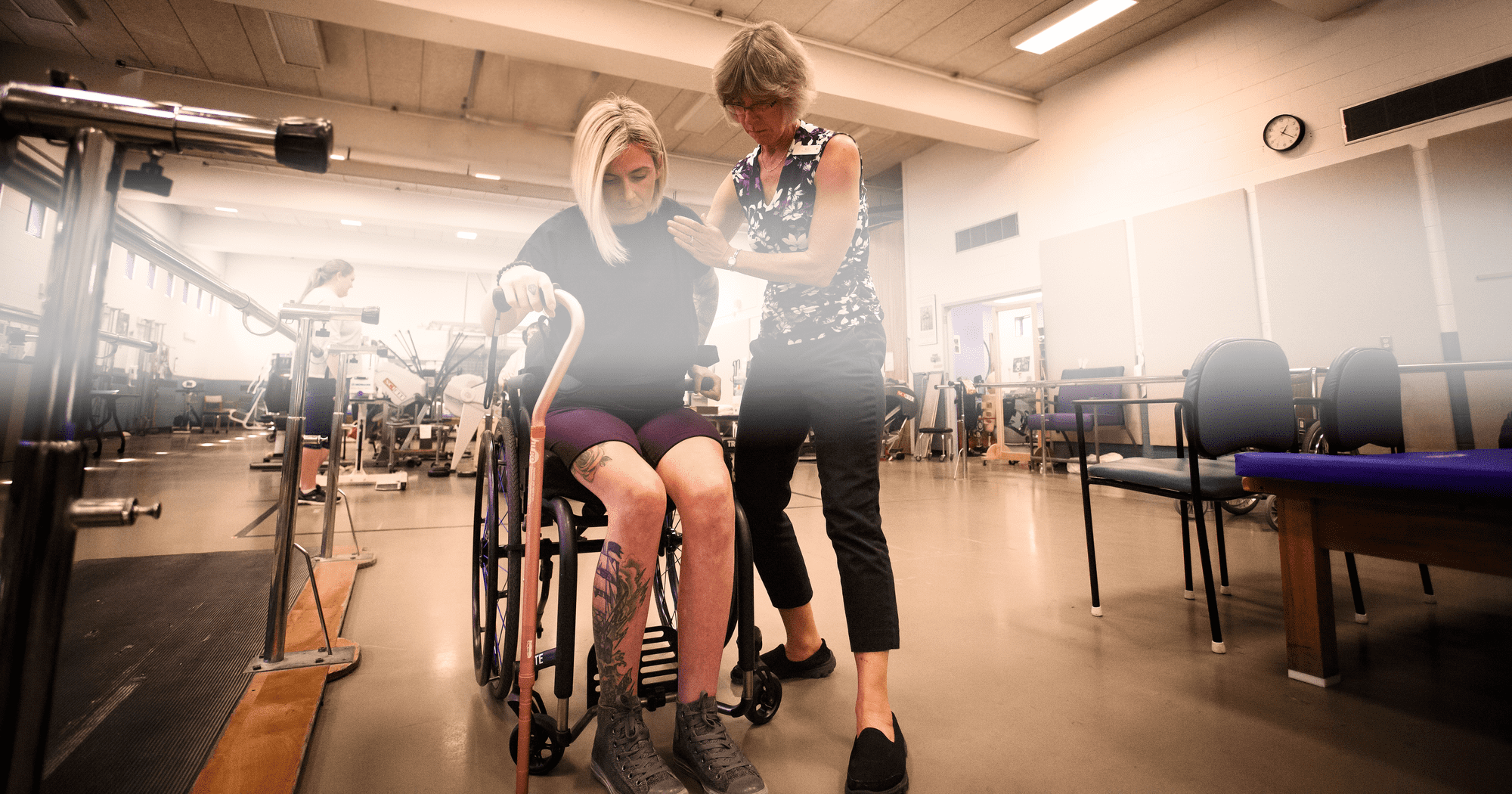 QEII background image: Wheel Chair Patient Being Rehabilitated