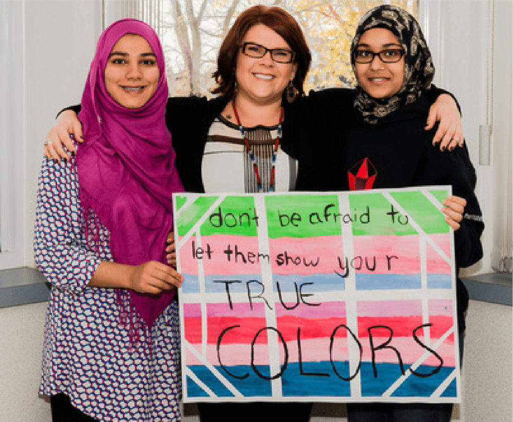 3 women holding a sign that says "don't be afraid to let them show your TRUE COLORS"